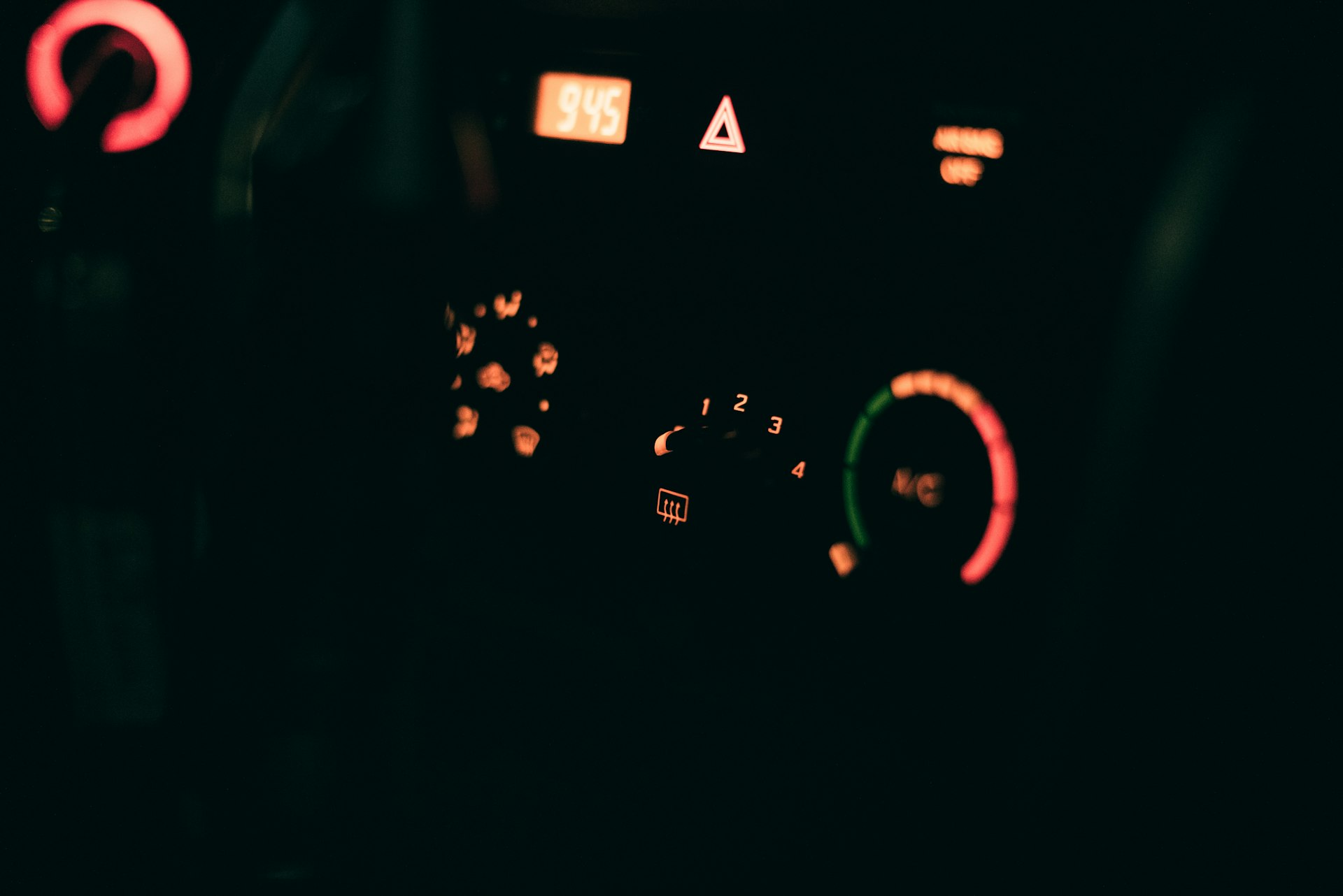 The dashboard of a car with the lights on